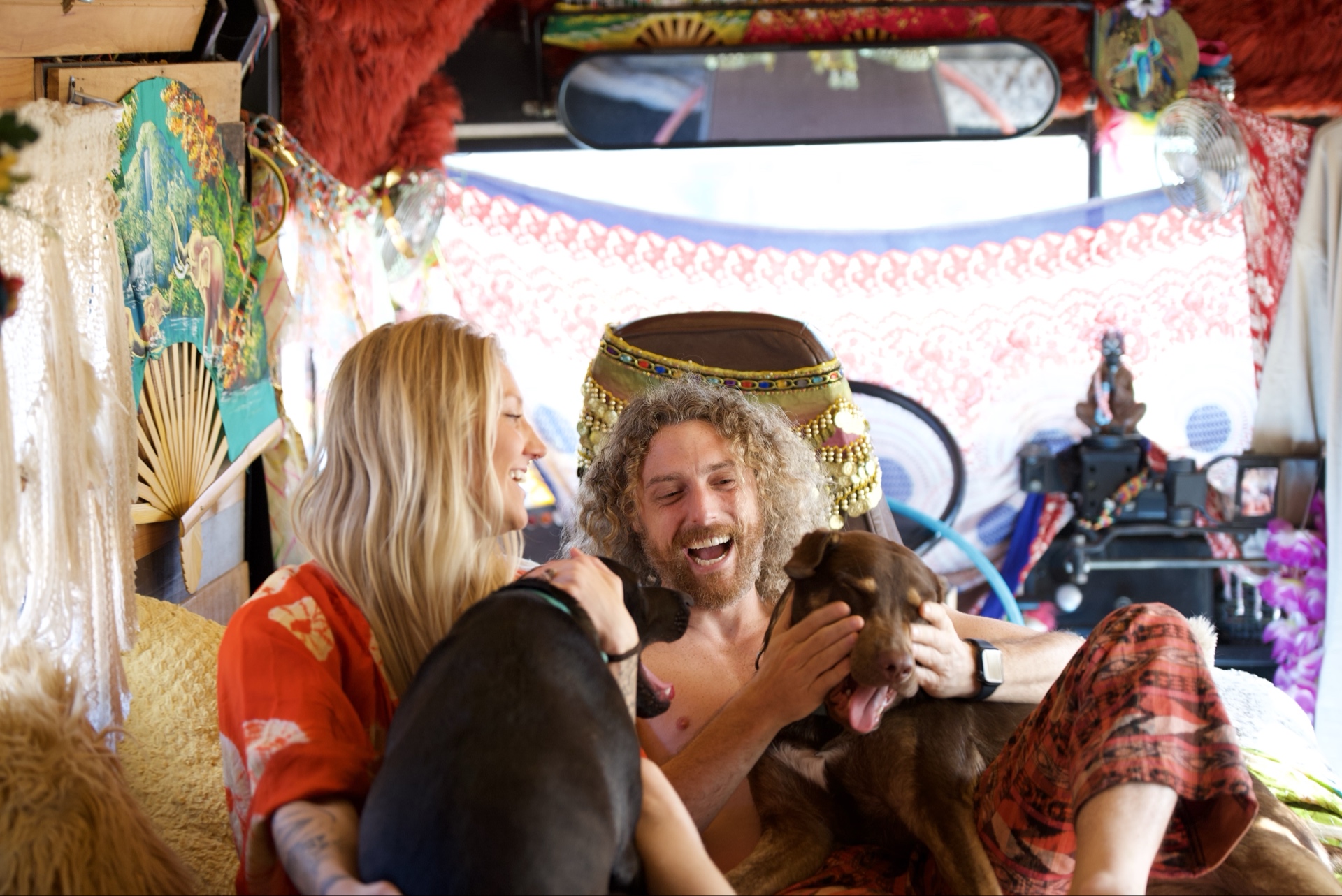 Holy Wild Music artists laughing together inside The Magic Fool Bus