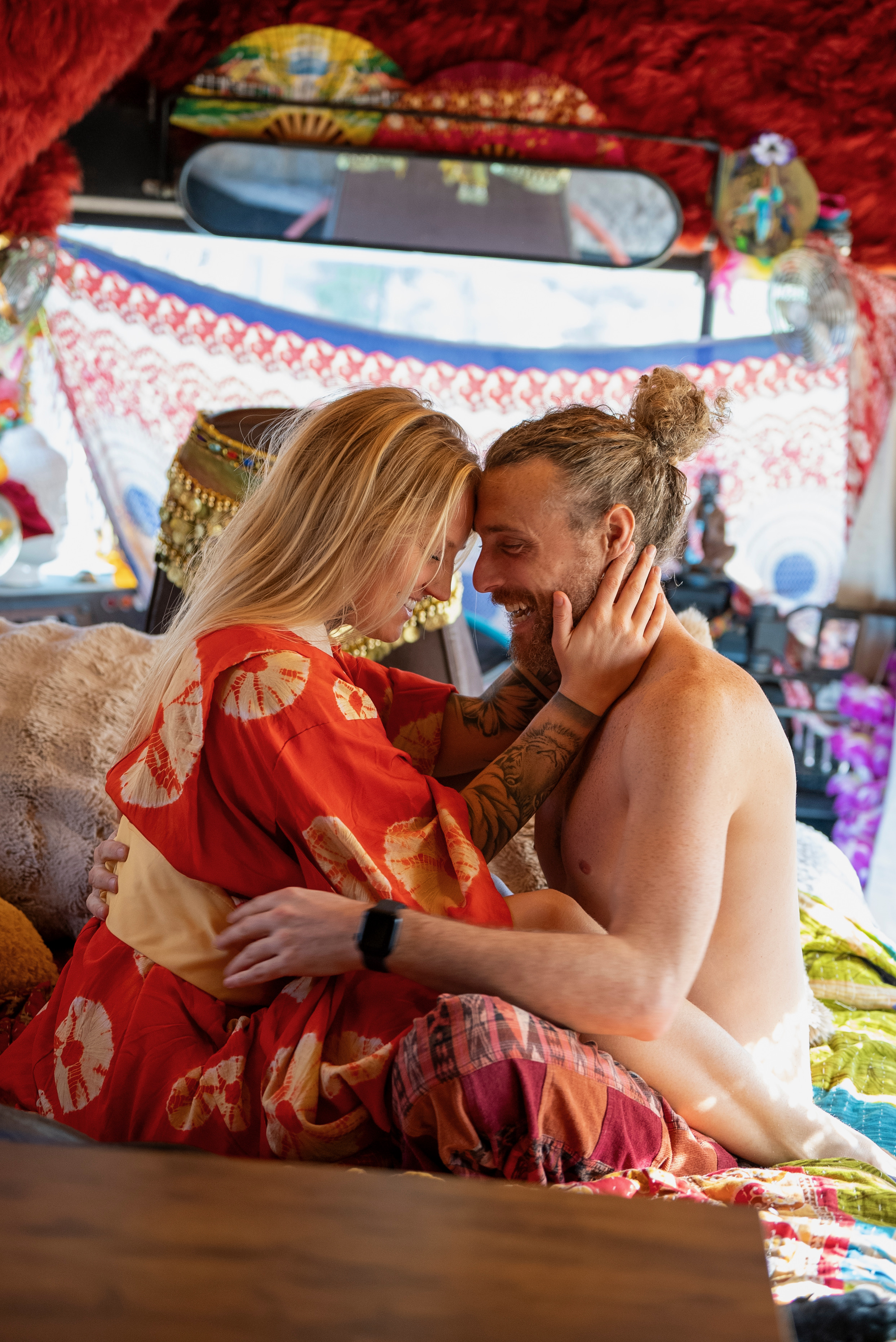 Holy Wild Music artists sharing a quiet intimate moment inside their art-filled bus